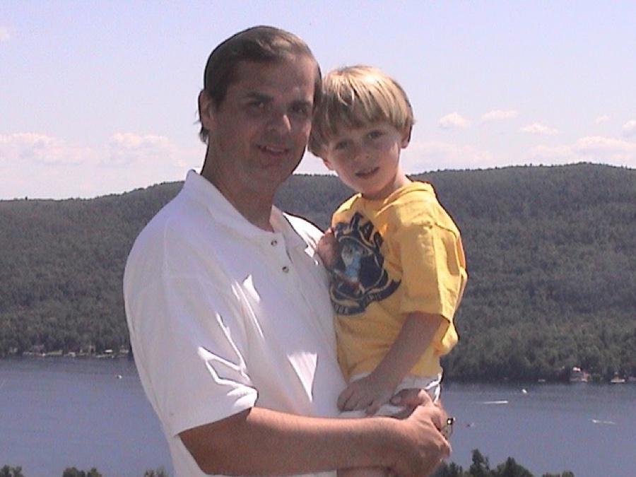 William holding young Billy by a lake
