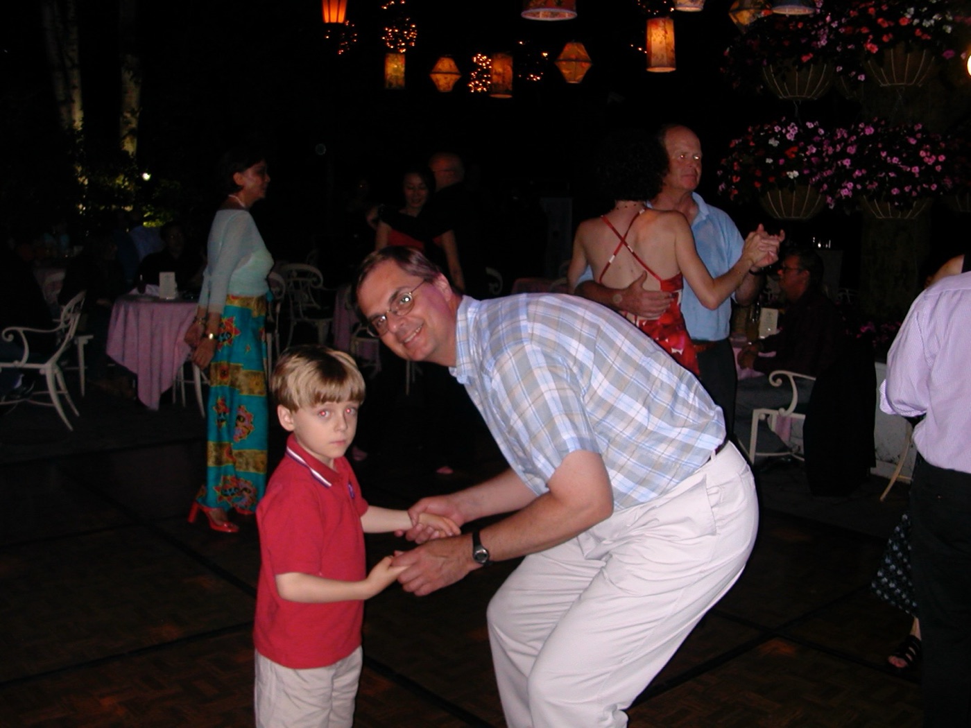 William dancing with young Billy at an evening celebration